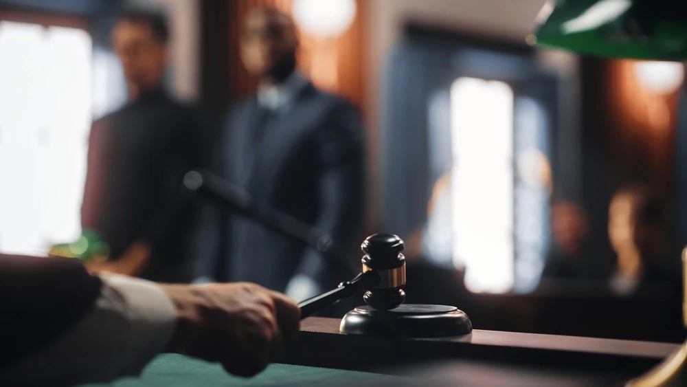 A judge passing sentence while a defendant and his lawyer look on