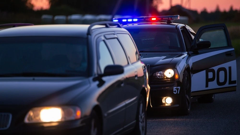 A patrol car pulling over another vehicle