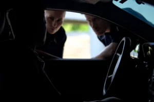 Police officers looking inside a suspect’s vehicle