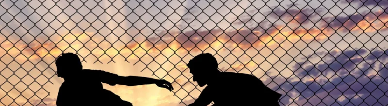 people crossing illegally through a border fence